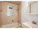 Bathroom features a tub, shower, vanity and unique glass block window at 1355 Rosemary St, Denver, CO 80220