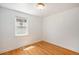 A bright bedroom with beautiful refinished hardwood floors and white trim at 1355 Rosemary St, Denver, CO 80220