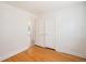 Bedroom features beautiful refinished hardwood floors and white trim with closet at 1355 Rosemary St, Denver, CO 80220