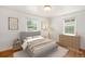 Inviting bedroom with hardwood floors, neutral walls, and two windows offering a serene atmosphere at 1355 Rosemary St, Denver, CO 80220
