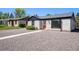Charming exterior with gray stucco, black trim, red door, and gravel yard at 1355 Rosemary St, Denver, CO 80220