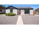 Charming exterior with gray stucco, black trim, and a red front door at 1355 Rosemary St, Denver, CO 80220