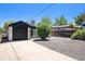 Charming home with a black garage and a low maintenance xeriscaped front yard at 1355 Rosemary St, Denver, CO 80220