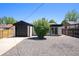Charming home with a black garage and a low maintenance xeriscaped front yard at 1355 Rosemary St, Denver, CO 80220