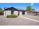 Charming exterior with grey stucco, red door, and gravel landscaping at 1355 Rosemary St, Denver, CO 80220
