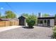 Charming home with a black garage and a low maintenance xeriscaped front yard at 1355 Rosemary St, Denver, CO 80220