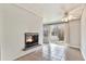 Cozy living room featuring a white-brick fireplace and a ceiling fan at 1355 Rosemary St, Denver, CO 80220