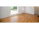 Bright living room features refinished hardwood floors and a large window with street view at 1355 Rosemary St, Denver, CO 80220
