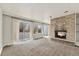 Inviting living room features a stone fireplace and sliding glass doors to the backyard at 1355 Rosemary St, Denver, CO 80220