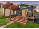 Outdoor patio area with a pergola covering the hot tub and steps leading up to the house at 3341 Newton St, Denver, CO 80211
