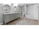 Bright bathroom featuring a double sink vanity, tiled floors, and a tub with shower at 3341 Newton St, Denver, CO 80211