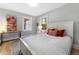 Comfortable bedroom with natural light, hardwood floors, and neutral decor at 3341 Newton St, Denver, CO 80211