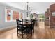 Bright dining room with hardwood floors, modern lighting, and an open layout to the kitchen at 3341 Newton St, Denver, CO 80211
