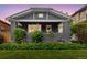 Charming home featuring a brick facade, covered front porch, and meticulously maintained landscaping at 3341 Newton St, Denver, CO 80211