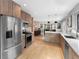 Modern kitchen featuring stainless steel appliances, custom cabinetry, and an island with quartz countertops at 3341 Newton St, Denver, CO 80211