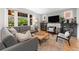 Cozy living room with a comfortable sofa, large windows, fireplace, and neutral decor at 3341 Newton St, Denver, CO 80211