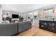 Spacious living room featuring hardwood floors, a fireplace, and access to the dining area at 3341 Newton St, Denver, CO 80211