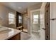 Bathroom featuring neutral tile and a glass-enclosed shower with a built-in bench at 17186 E Cedar Gulch Dr, Parker, CO 80134