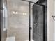 Modern bathroom featuring a glass shower with sleek black hardware at 17186 E Cedar Gulch Dr, Parker, CO 80134