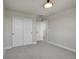 Bright bedroom with neutral carpet, closet with sliding doors, and ensuite bath at 17186 E Cedar Gulch Dr, Parker, CO 80134