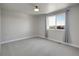 Bedroom with a large window and neutral carpet at 17186 E Cedar Gulch Dr, Parker, CO 80134