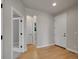 Bright hallway with hardwood floors and multiple doorways, offering access to different areas of the home at 17186 E Cedar Gulch Dr, Parker, CO 80134