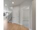 Hallway view showcasing hardwood floors and an open doorway leading to a carpeted room at 17186 E Cedar Gulch Dr, Parker, CO 80134