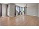 Open-concept room featuring three large windows, hardwood floors, and stylish lighting at 17186 E Cedar Gulch Dr, Parker, CO 80134