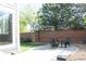Backyard patio featuring outdoor seating and a brick fence providing enhanced privacy at 1710 S Poplar St, Denver, CO 80224