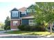 Traditional two-story home with brick accents, lush landscaping, and a well-manicured front lawn at 1710 S Poplar St, Denver, CO 80224