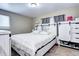 Main bedroom with a king-size bed, built-in shelving, and ample closet space at 2391 Lansing St, Aurora, CO 80010