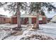 Brick ranch house with snowy front yard at 2391 Lansing St, Aurora, CO 80010