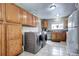 Kitchen with wood cabinets, white appliances, and tile floor at 2391 Lansing St, Aurora, CO 80010