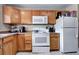 Bright kitchen boasts ample cabinetry, a microwave, and a free-standing electric range at 2391 Lansing St, Aurora, CO 80010