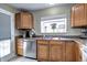 Well-equipped kitchen featuring wood cabinets, stainless steel appliances, and a window above the sink at 2391 Lansing St, Aurora, CO 80010