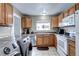 Open concept kitchen with stainless steel appliances and wood cabinets at 2391 Lansing St, Aurora, CO 80010