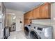 Convenient laundry room with side-by-side washer and dryer, and access to the dining area at 2391 Lansing St, Aurora, CO 80010