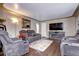 Living room with fireplace, hardwood floors, and gray couches at 2391 Lansing St, Aurora, CO 80010