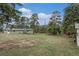 Expansive backyard showcasing a well-maintained lawn and mature trees creating a peaceful outdoor space at 4295 Picutis Rd, Indian Hills, CO 80454