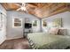 Serene bedroom with wood paneled ceiling, natural light, and calming decor for a comfortable retreat at 4295 Picutis Rd, Indian Hills, CO 80454