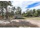 Charming exterior view with a well-maintained lawn, siding, a sun room, and mature trees in a serene setting at 4295 Picutis Rd, Indian Hills, CO 80454