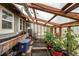 Bright greenhouse filled with plants, wooden beams, natural light and potting bench at 4295 Picutis Rd, Indian Hills, CO 80454
