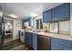 Functional kitchen featuring painted blue cabinets, modern appliances, and natural light at 4295 Picutis Rd, Indian Hills, CO 80454