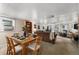 Open concept with a dining area featuring a wooden table adjacent to the cozy living room at 4295 Picutis Rd, Indian Hills, CO 80454