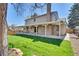 Expansive backyard features a lush lawn, brick patio, and covered space for outdoor entertaining at 8095 Johnson Ct, Arvada, CO 80005