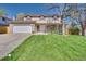 Charming two-story home featuring an attached two-car garage and a well-manicured lawn at 8095 Johnson Ct, Arvada, CO 80005