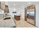 This modern kitchen features stainless steel appliances, an island with seating, and an open layout at 8095 Johnson Ct, Arvada, CO 80005