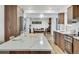 This kitchen boasts an island with seating, modern appliances, and an open design leading to the dining and living areas at 8095 Johnson Ct, Arvada, CO 80005