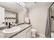 Bright bathroom featuring a granite countertop, modern fixtures, and a shower with checkered tile accent at 1630 Egret Way, Superior, CO 80027