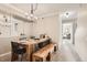 A modern dining room with a wooden table and bench, perfect for Gathering gatherings and entertaining guests at 1630 Egret Way, Superior, CO 80027